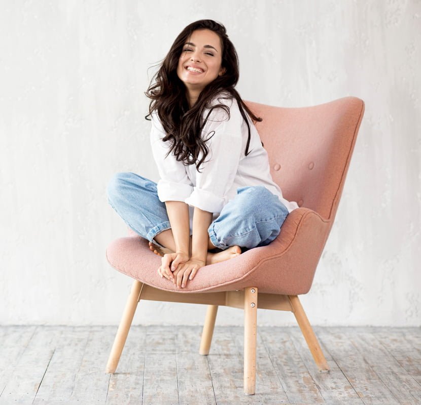 front view smiley woman posing chair